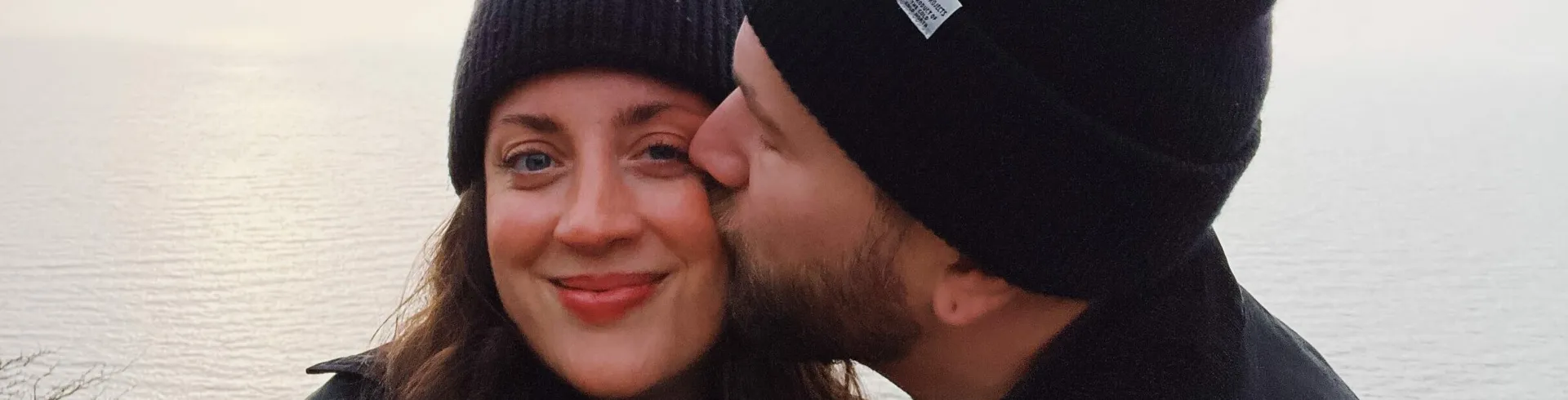 A man kissing a woman on the cheek.
